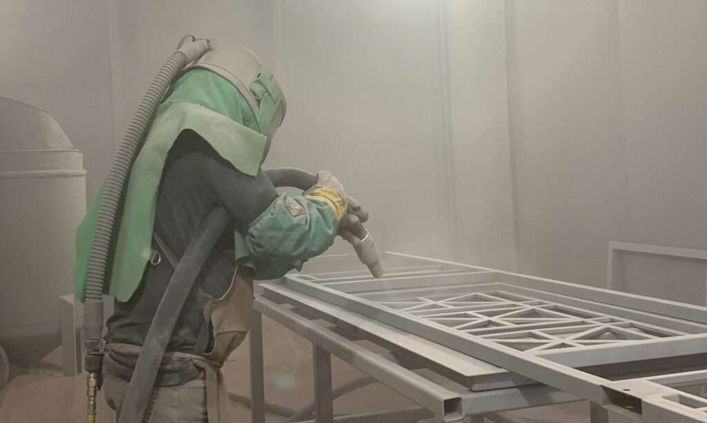 Sandblasting process, a man with blast.